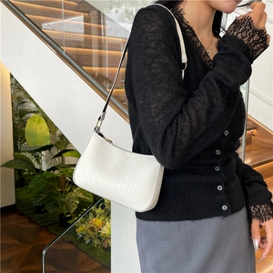 White faux crocodile skin crossbody bag for women shown with model on stairs