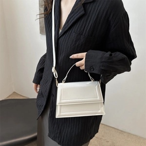 Minimalist white envelope crossbody bag with top handle and adjustable strap for women