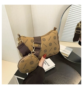 Brown vintage crescent bag with wide fabric strap and matching round mini coin purse detail