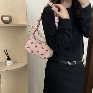 Pink corduroy crescent underarm bag with strawberry embroidery and ruffled strap