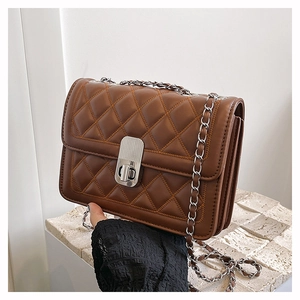 Detail view of brown quilted chain crossbody bag showing multi-layer accordion structure