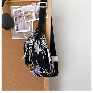 Detail of black chest bag with colorful wave embroidery and star-shaped charms