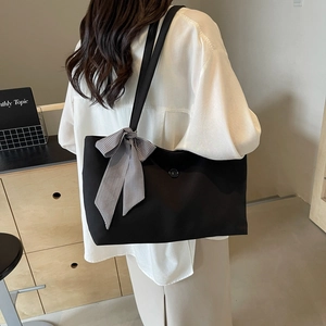 Large black tote bag for women featuring a stylish gingham bow on the shoulder strap