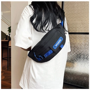 Detail of black chest bag with blue strap and WOAINI badge shown on person