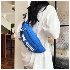 Detail of blue nylon chest bag with white WOAINI patch and adjustable buckle strap