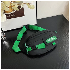 Detail of street style waist bag with black fabric and vibrant green contrast straps