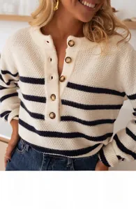 Detail of a beige striped knit sweater featuring a button-up Henley neck and soft texture
