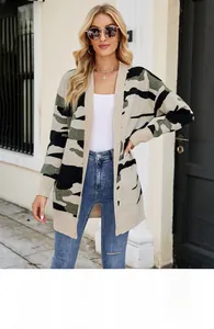 Detail view of a long camouflage knit cardigan in beige, olive green, and black patches
