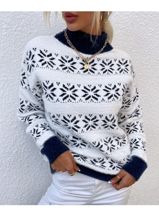 Close-up of knit winter sweater showing navy snowflake patterns and ribbed texture