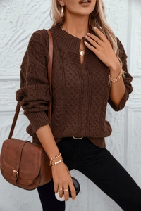 Detailed cable knit texture of a brown oversized sweater with a V-split turtleneck collar