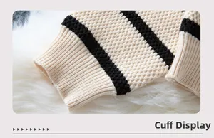 Detail of waffle knit texture and ribbed cuffs on beige striped pullover sweater