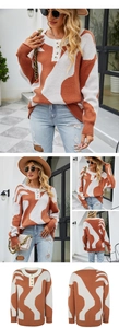 Dettaglio del maglione in maglia arancione e beige con scollo Henley e bottoni