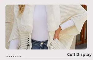 Detail of knit cape sleeve showing soft tassels and faux fur collar in cream white