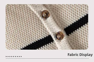 Macro view of beige waffle knit cardigan with contrast black stripes and button detail