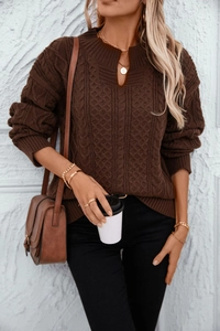 Detail of dark brown cable knit sweater featuring a stand collar and V-neckline texture