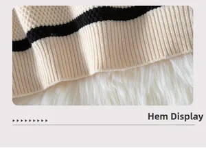 Close-up of the ribbed hemline on a beige and black striped knit sweater for women