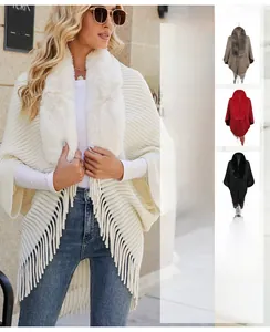 Detail of elegant knit shawl with large faux fur collar and fringe hem in various colors