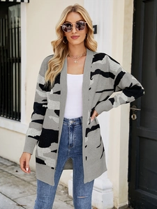 Detail of a camouflage knit cardigan with grey and black patterns in longline open-front style