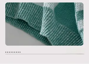 Macro shot of green and white striped knit sweater showing elastic ribbed hem detail