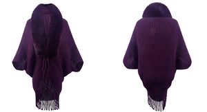 Detailed view of purple knit poncho featuring a plush fur collar and elegant fringe hem