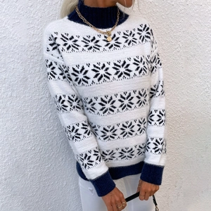 Women's turtleneck knit sweater featuring Nordic snowflake patterns in navy and white