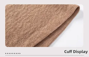 Close-up of knit sweater cuff detail with ribbed texture and warm brown yarn finish