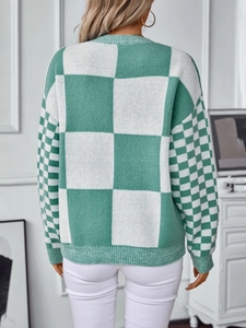 Women's oversized green and white checkerboard knit sweater with casual round neck style