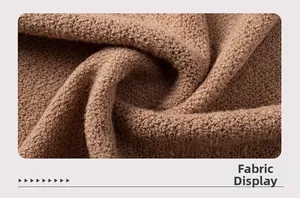 Close-up of textured brown knit fabric with thick boucle yarn and hollow-out detailing