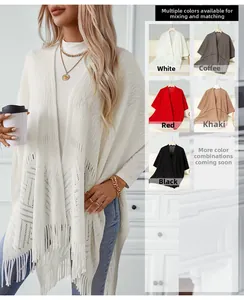 Detail of hollow-out knit pattern and fringe hem on solid color tassel poncho wrap