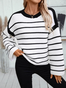 Close-up of black and white striped knit sweater showing ribbed crew neck and texture
