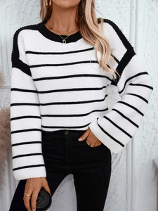 Oversized black and white striped knit sweater with crew neck and flared sleeves
