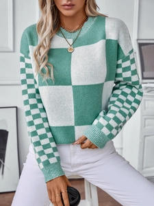 Women's green and white checkered knit sweater with a round neck and casual style