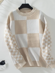 Close-up of knit texture on checkered pattern sweater with ribbed neckline and cuffs