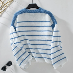 Close-up of blue and white striped knit sweater showing soft texture and round neck