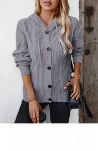 Close-up of grey cable-knit hooded cardigan featuring stylish dark toggle buttons and drawstrings