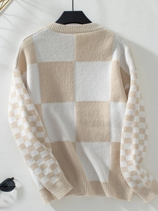 Detail of contrasting checkerboard knit sweater with textured cuffs and soft fabric