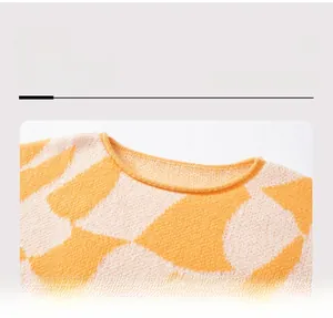 Detail of the crew neckline on a vibrant color block jacquard knit sweater for women