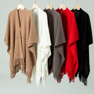 Detail showing various colors of hollow out knit shawls with long fringe tassels