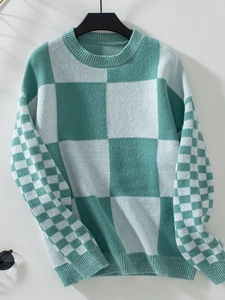 Detail of mint green and cream checkerboard knit sweater with ribbed cuffs and collar
