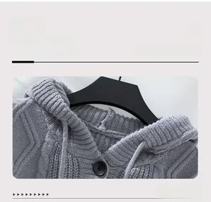 Detailed view of the drawstring hood and cable knit texture on a grey cardigan sweater