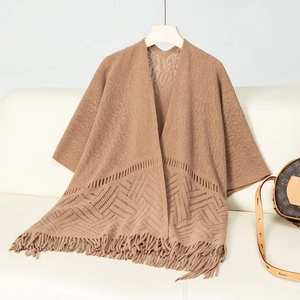 Detailed knit pattern and fine fringe tassels on a brown open-front hollow poncho