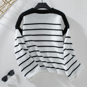 Detail of loose-fit striped knit sweater showing thick texture and drop shoulder design