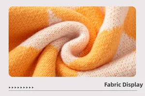 Detailed fabric close-up of orange and white chunky knit sweater with soft texture