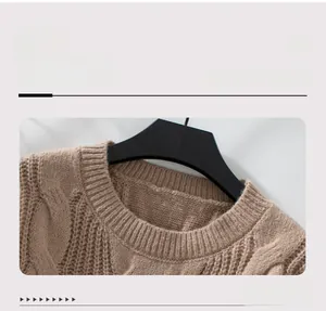 Close-up of beige cable knit sweater showing textured crew neck and ribbed collar details