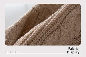 Close-up of camel cable knit texture showing detailed stitching on the wool sweater