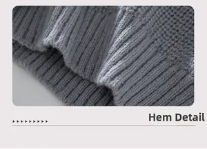 Detailed macro view of the ribbed knit hem on a grey hooded cardigan sweater coat