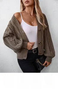 Detail of dark brown cable-knit cardigan with tortoiseshell buttons and V-neckline