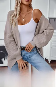 Detail of oversized oatmeal knit cardigan with textured vertical ribbing and drop shoulder
