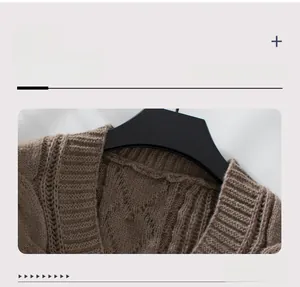 Detail view of the ribbed neckline and cable knit texture on a brown cardigan