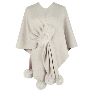 Elegant oatmeal knitted poncho cape with faux fur trim collar and hanging pom-pom details